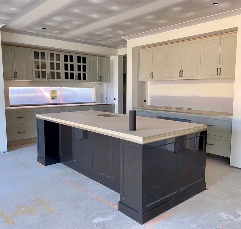 Painted kitchen cabinetry and island installed in a new-build home