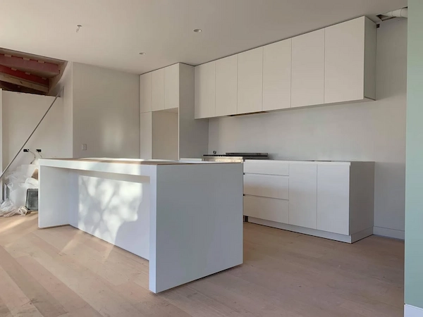 White kitchen island and cabinetry mid-renovation