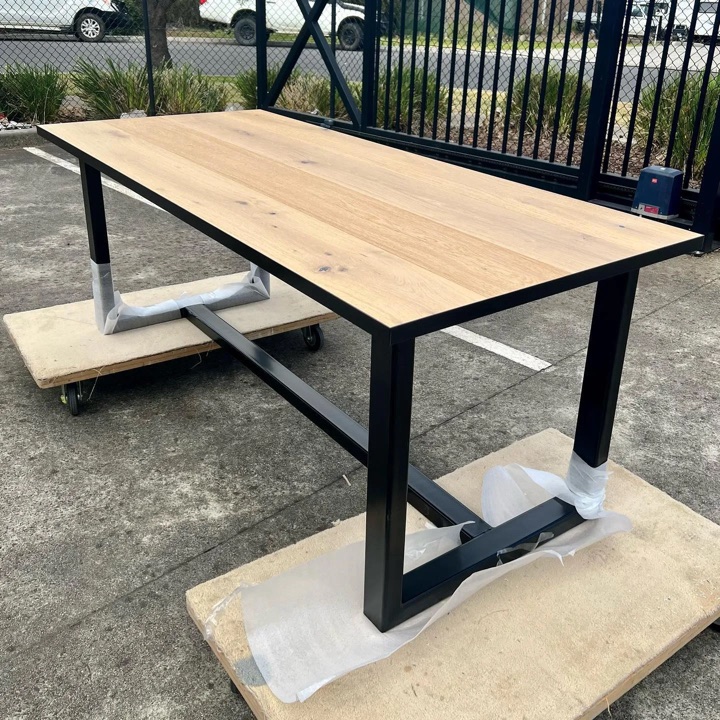 Rectangular brown plank tabletop on a dark frame